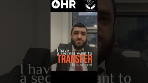 Man in a suit seated in an office, with bold orange text saying 'TRANSFER this secret' overlaid on him; OHR logos at top.