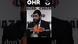 Bearded man in a suit speaks into a microphone at a panel, with a backdrop reading 'AZAQ' logos and an overlay message: 'don't get MAD at people,' plus an OHR logo at the top.