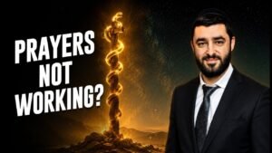 Thumbnail for a video: a glowing, snake-wrapped staff on rocky ground with a man in a suit on the right, and the words 'PRAYERS NOT WORKING?' in bold white letters.