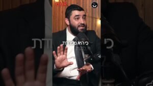 Bearded man in a suit speaks into a microphone during a podcast, gesturing with his hands, wooden studio backdrop and logos above. Text overlay in Hebrew across the center.
