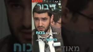 Close-up of a man in a suit being interviewed, with turquoise Hebrew subtitles overlaid.